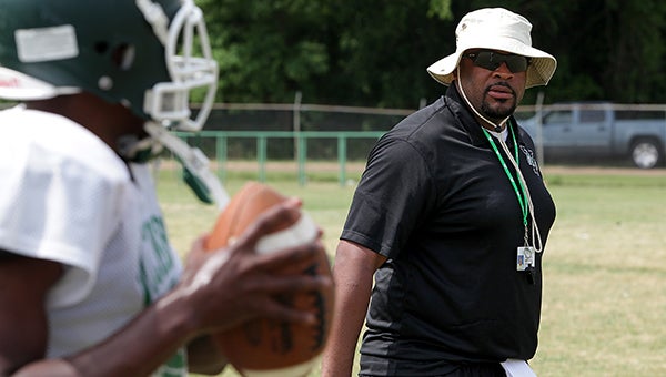 Vicksburg head football coach Marcus Rogers watches over quarterback drills Tuesday during spring training at the VHS practice field. (Justin Sellers/The Vicksburg Post)