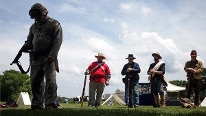 Re-enactors pause for a moment of silence Saturday during the Soldiers Thru the Ages exhibit at the Vicksburg National Military Park.