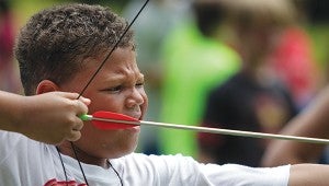 Beau Harris, 7, takes aim with an arrow Wednesday during Winshape Camp at Crossway Church. (Justin Sellers/The Vicksburg Post)