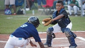Jefferson catcher Trez Bershell, 11, catches the ball as AT&T's William Jackson, 11, slides into home plate.