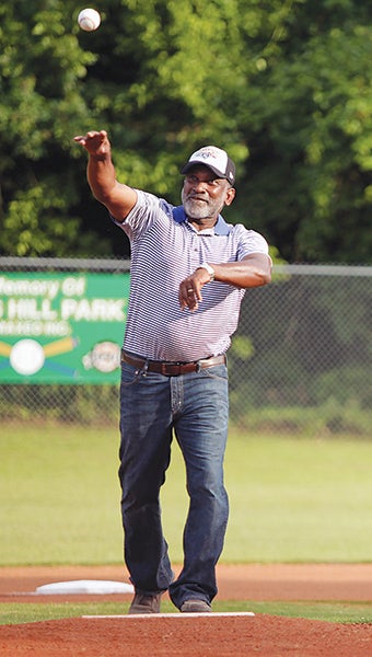 District 55 Representative Oscar Denton throws the first pitch of the season opener of the Fuzzy Johnson Baseball League Friday after the opening ceremony in which AT&T Executive Director of External Affairs Michael Walker presented a check for $5,000. (Justin Sellers/The Vicksburg Post)