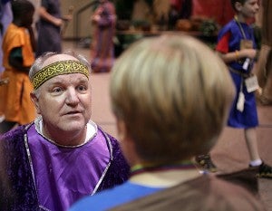 Paul Barnes, playing Matthew the Tax Collector, tests the knowledge of children on their Bible verses Thursday during Vacation Bible School at Hawkins United Methodist Church.
