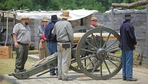 Living history volunteers prepare to fire a cannon Friday at the Vicksburg National Military Park. 