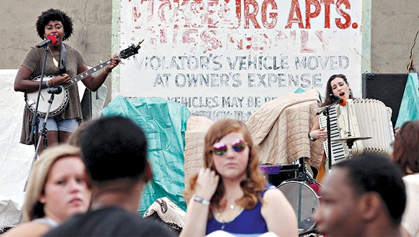 Festival-goers listen as Tallulah based band Silo plays Saturday at the Downtown Crawfish and Music Festival on Walnut Street behind the Vicksburg Apartments. 