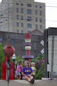 Lorren Peters, center, sits Wednesday morning at Vicksburg City Front with her children, Allie, 6, left and Jacob Peters, 3. They were at City Front to support Lorren Peters' fiancé who works on a boat that was being blessed. (Justin Sellers/The Vicksburg Post)