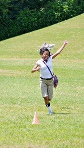 8th-grader Mykenya Davis, 12 runs with the kite her group made Friday.