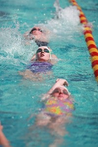 Biloxi resident Julie Myers, 17, center, practices Saturday along with dozens of other young swimmers participating in a clinic by Olympic gold medal swimmer Jason Lezak at Vicksburg City Pool as a part of Mississippi Swimming's state convention being held in Vicksburg. (Justin Sellers/The Vicksburg Post)