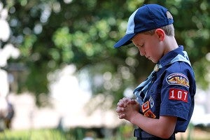 Pack 107 Cub Scout Connor Johnston, 9, bows his head and folds his hands in prayer Wednesday afternoon during a Constitution Day ceremony at the Old Court House Museum, marking the 227th anniversary of the drafting of the Constitution.