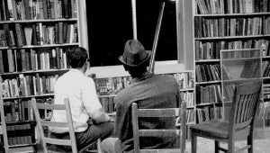 Two unidentified men guard the Vicksburg Freedom House in the summer of 1964 in this photo from the Tougaloo College collection.