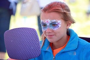 Vicksburg native Maddie Rice, 8, checks out her painted face Saturday morning at the Fall Festival downtown. (Justin Sellers/The Vicksburg Post)