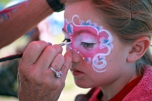 Vicksburg native Gracie Griggs, 8, has her face painted by Sherry Burdsal, owner of Fancy Faces, Saturday morning at the Fall Festival downtown. (Justin Sellers/The Vicksburg Post)