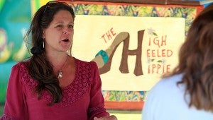 The High Heeled Hippie owner Peyton Johnson Collins helps a customer Saturday morning at the downtown Farmers' Market. (Justin Sellers/The Vicksburg Post)