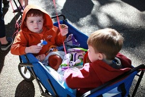 Braxton Pace, 3, left, and Greyson Pace, 2, ride in a wagon Saturday morning on Jackson Street during the Old Court House Flea Market. (Justin Sellers/The Vicksburg Post)