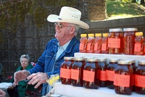 Sid Ervin talks to customers about his honey Saturday during the Old Court House Flea Market. (Justin Sellers/The Vicksburg Post)