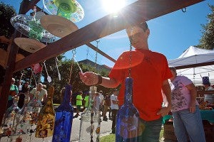 Visitors check out homemade wind chimes and bird feeders Saturday morning during the Old Court House Flea Market. (Justin Sellers/The Vicksburg Post)