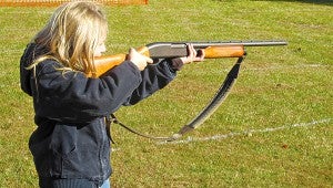 Alana Hearn, 11, daughter of Scott and Melissa Hearn and a sixth grader at Redwood Elementary, sights her gun as she gets ready to take a shot at a target at Saturday’s turkey shoot. Alana, who has been hunting for five years, was attending her second turkey shoot. 