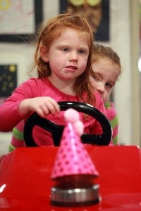 McKinley Owen, 4, left, and Mia Grace Owen, 6, ride in a fire truck Saturday in the Vicksburg Mall during Vicksburg-Warren School District's Showcase of Schools. (Justin Sellers/The Vicksburg Post)