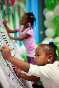 KeArriah Rowster, 3, colors Saturday in the Vicksburg Mall during Vicksburg-Warren School District's Showcase of Schools. (Justin Sellers/The Vicksburg Post)