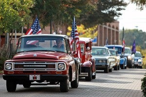 Vehicles adorned with flags head down Washington Street Tuesday morning during the annual Veterans Day parade in downtown Vicksburg. (Justin Sellers/The Vicksburg Post)
