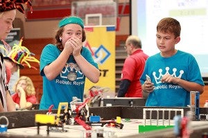 Robotic Royals team member Emilee Bloodworth, 11, left,  reacts after her robot failed to perform a task while teammate Cody North, 10, watches Saturday afternoon during the FIRST LEGO League qualifier at Warren Central. (Justin Sellers/The Vicksburg Post)