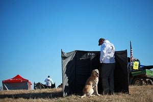 Yellow labrador retriever Magic Tricks Autumn Creek Tazz sits behind a blind Tuesday with handler Paul Sletten before going on a run during the National Retriever Club's 2014 National Championship Stake at a 2400-acre estate in Bovina. Sletten was one half of the duo that won the championship in 2010 – the last time the event was held in Warren County. (Justin Sellers/The Vicksburg Post)