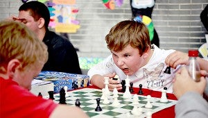 Brandon Turner, a sixth-grader at Redwood, makes a face to intimidate his opponent in a game of chess.