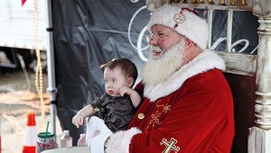 SANTA’S LAP: Hadley Rayborn/Croftwell, 8 months, sits on Santa’s lap Friday as the Kansas City Southern Holiday Express came to Vicksburg. The train visits every two years.