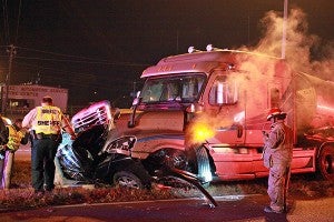 Emergency workers respond to the scene of a two-vehicle wreck Thursday night in between Interstate 20 and N. Frontage Road that took the life of Andrea Thomas. (Justin Sellers/The Vicksburg Post)
