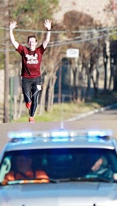 CRUISING: Tom Lilleyman raises his arms during the Chill in the Hills 10K run Saturday morning. Lilleyman won the race with a time of 39 minutes, 46 seconds. (Paul Ingram•For The Vicksburg Post)