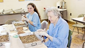 PREPARATIONS: Sarah Thomas learns how to make kibbee from Sue Thomas.