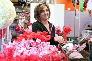 Geni Fulcher, owner of The Ivy Place, prepares decorations Thursday afternoon in the shop in preparation for Valentines Day. (Justin Sellers/The Vicksburg Post)