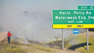 DRY CONDITIONS: Vicksburg firefighters work to extinguish a grass fire in October between U.S. 61 South and the Halls Ferry Road exit off eastbound Interstate 20. Due to dry conditions county supervisers have issued a burn ban. (Justin Sellers / The Vicksburg Post)