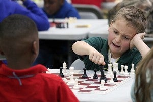 Warrenton Elementary third-grader Wade Cochran, 9, makes a move Friday morning in the GATES chess tournament at Beechwood Elementary.