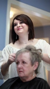 Hairstylist McMillan Crevitt styles the hair of Joan Leese at Southern Barber and Style Shop. (Justin Sellers/The Vicksburg Post)