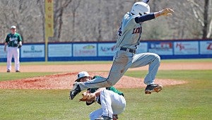 Lewisburg’s Micah Nichols leaps over Vicksburg High pitcher Will Martin as Martin fields a grounder in the fourth inning Saturday. (Ernest Bowker/The Vicksburg Post)