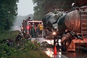 Emergency responders work to clear the scene of a one-vehicle 18-wheeler wreck in the westbound lane of Interstate 20 Monday morning which left the truck driver dead.  The wreck happened Sunday night at about 11:30 near mile marker 8 and emergency personnel worked until 5 a.m. to get the truck out, which spilled about 4,000 gallons of motor oil. (Justin Sellers/The Vicksburg Post)