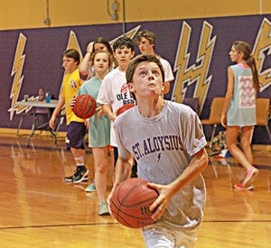 Phillip Upshaw drives in for a layup Monday at the Delvin Thompson Basketball School summer camp at St. Aloysius. The camp is for children in grades 1-8 and continues through Friday. (Ernest Bowker/The Vicksburg Post)