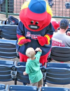 Mississippi Braves mascot “Trusty” gives a high-give to a young fan during Sunday’s game against Pensacola at Trustmark Park in Pearl. (Ernest Bowker/The Vicksburg Post)