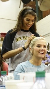 Arrielle Dale, Miss New South, shows Hannah Hathorn, Miss Clinton, a fun hairstyle backstage during a Monday morning rehearsal at the Vicksburg Convention Center. (Alaina Denean Deshazo)