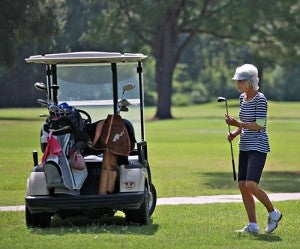 Linda McHann walks back to her cart after hitting an approach on the eighth hole Wednesday at Clear Creek Golf Course. (Ernest Bowker/The Vicksburg Post)