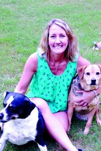 RESCUE SHELTER: Leigh Conerly, Paws president, with two rescue dogs, Stella and Hazel, has been involved with PAWS since the beginning.